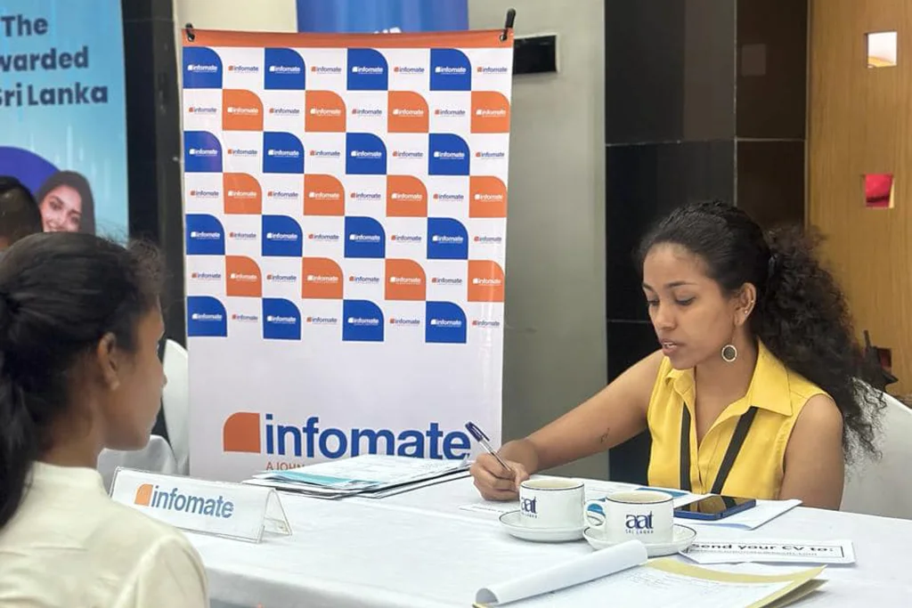 An Infomate recruitment officer interviewing a candidate at a career fair in Colombo.