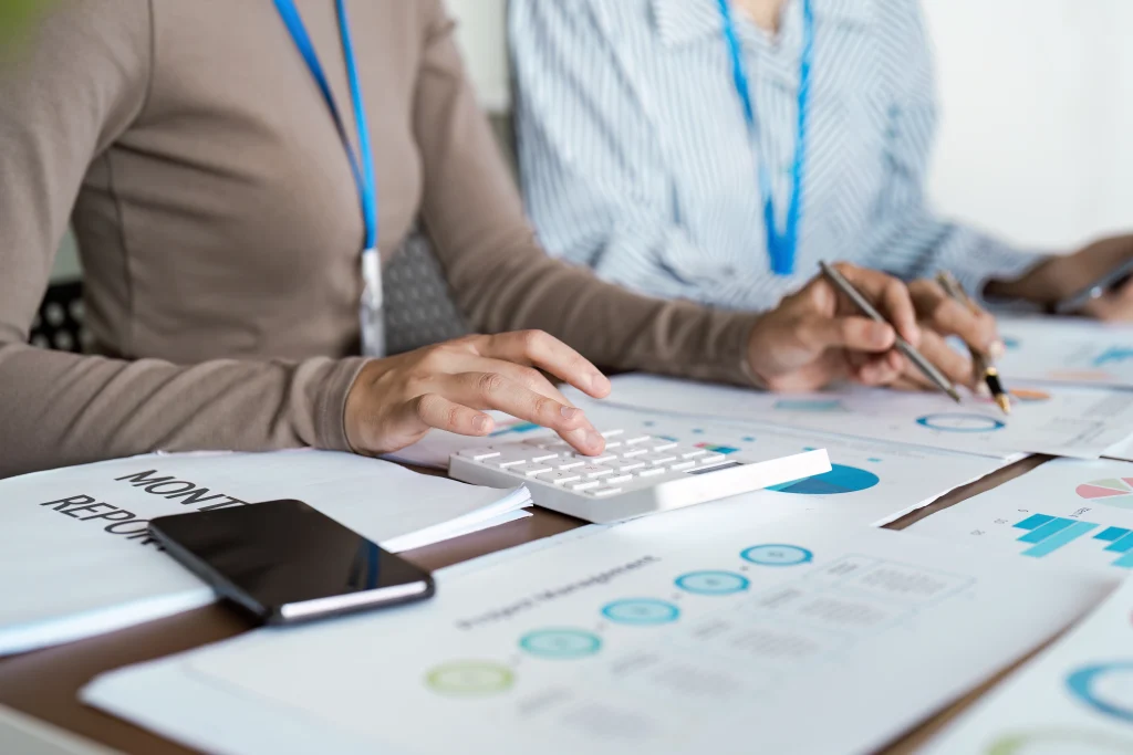 Close-up of corporate professionals calculating financial analytics and managing record to report workflows at a BPO company in Colombo.