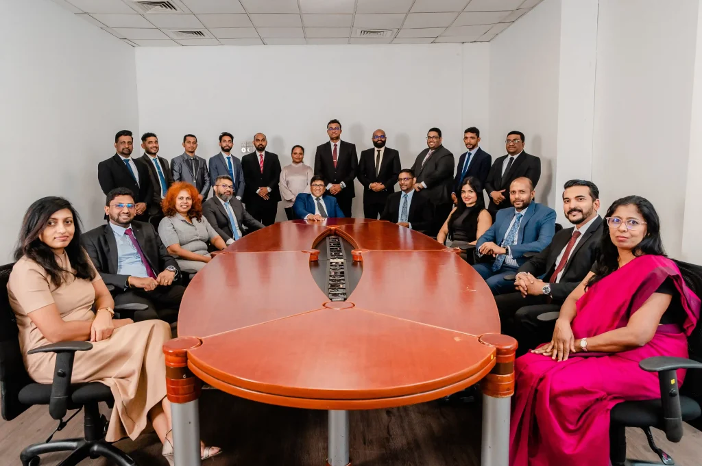 The executive leadership and management team gathered in a boardroom at Infomate, a leading BPO company in Sri Lanka.