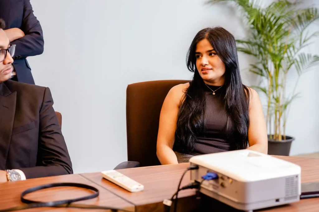 A female corporate professional listening to a business presentation in a conference room at Infomate, a leading BPO company in Sri Lanka.