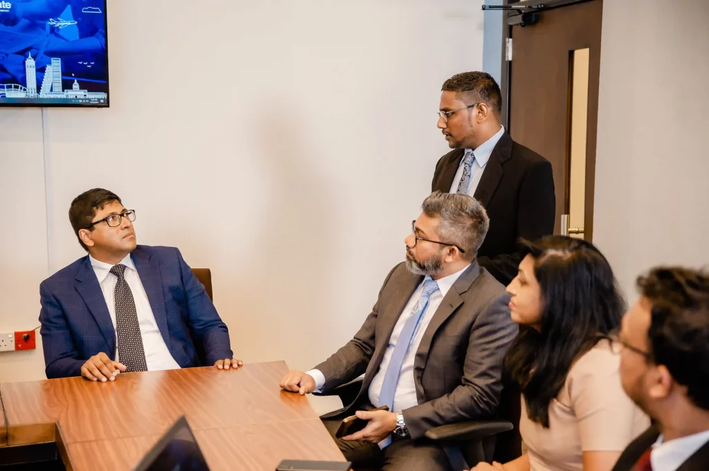 Infomate corporate management team collaborating during a strategic B2B business process outsourcing meeting in a Colombo boardroom.