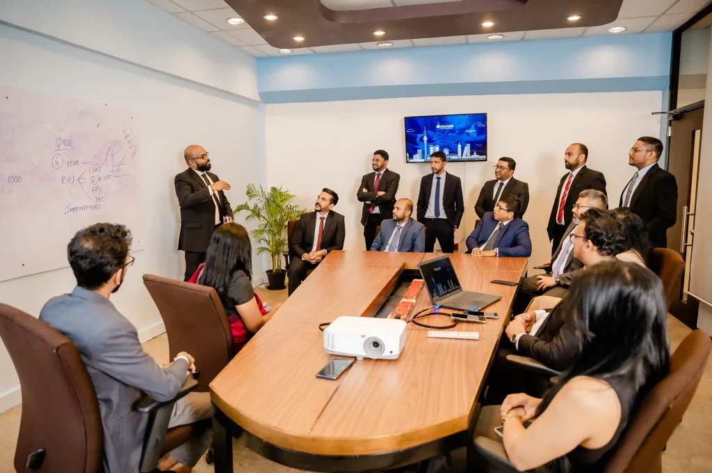 Corporate professionals collaborating on business metrics and performance analytics during a boardroom presentation at a top BPO company in Colombo.