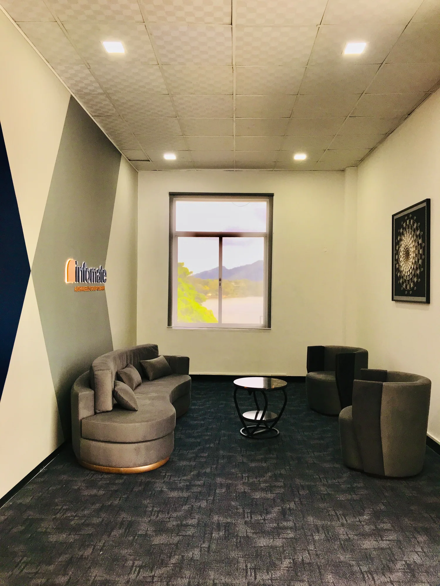 Lounge area with sofa and armchairs overlooking the view at the Infomate Kurunegala office
